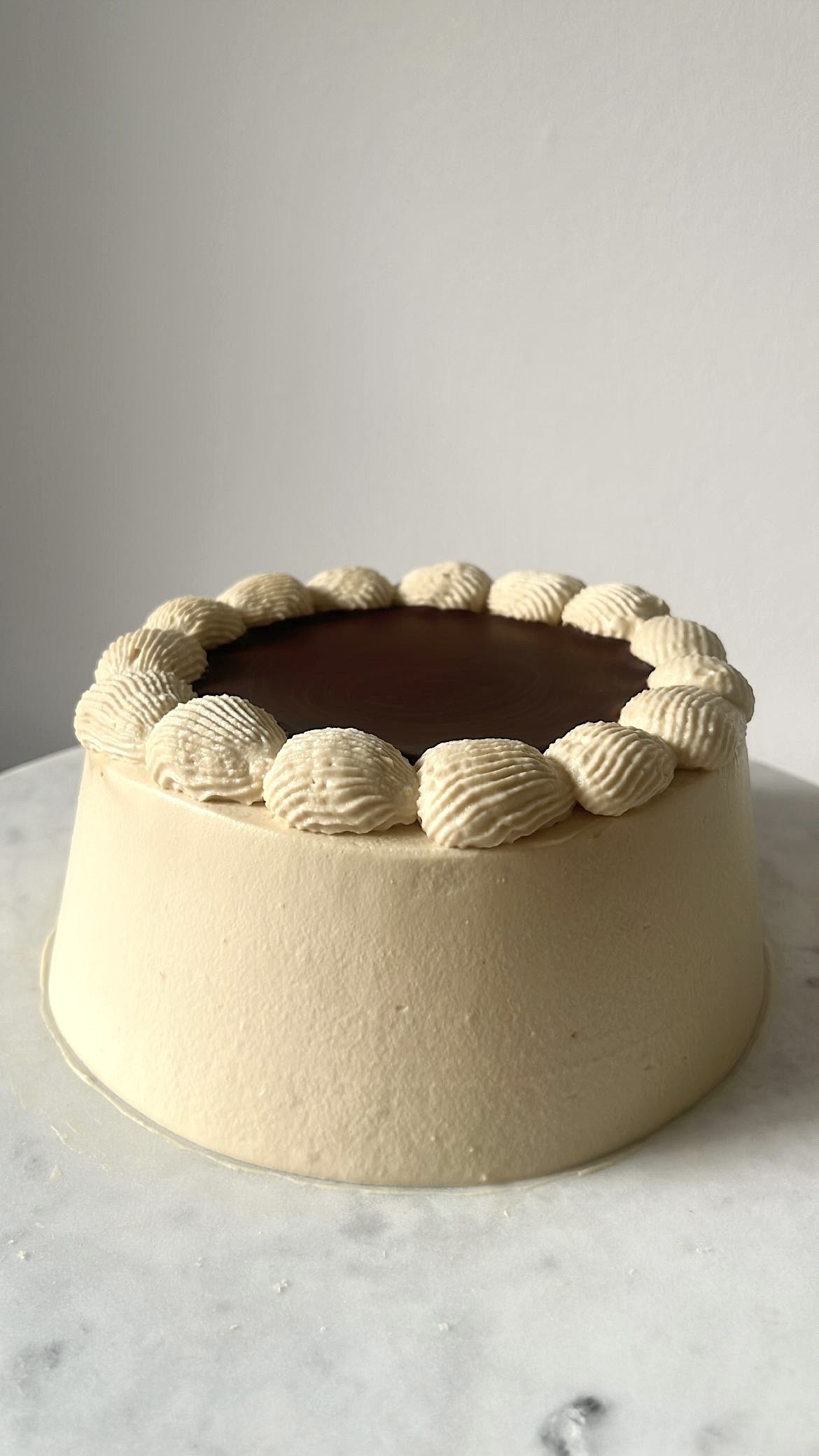 Coffee genoise cake covered with a smooth layer of coffee cream.