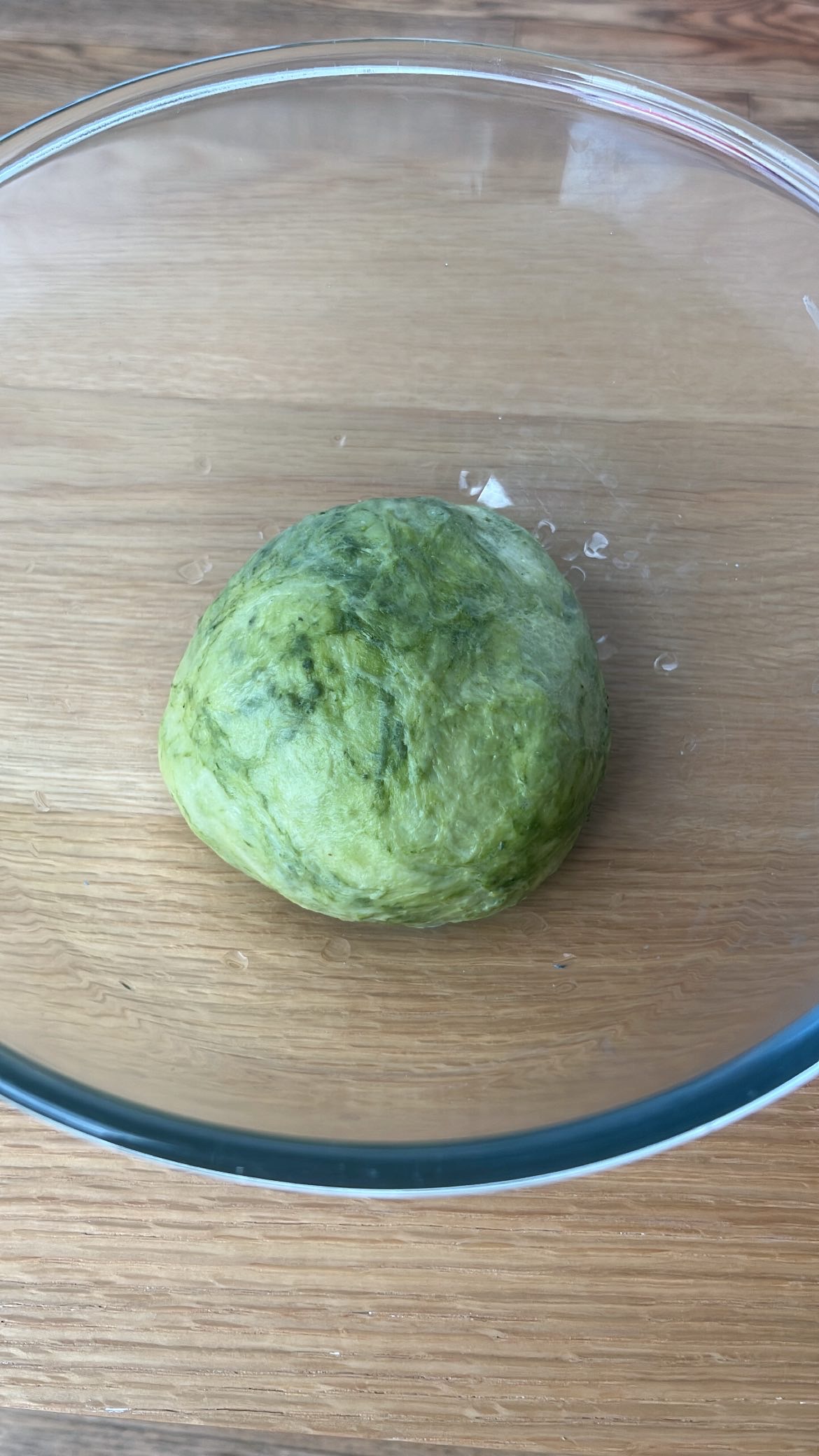 Mixing matcha powder into half of the dough to create a green color