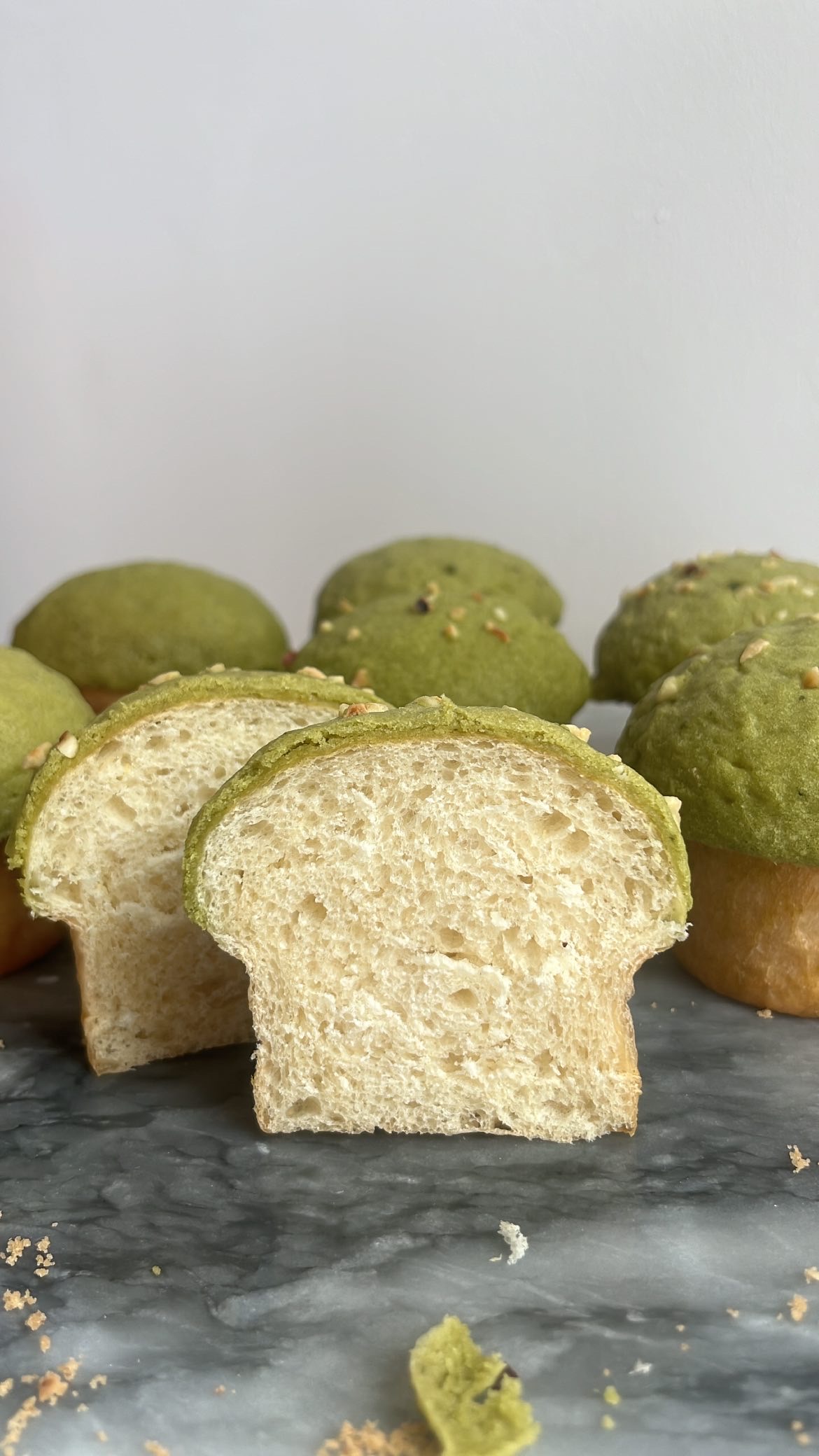 Matcha mushroom bread sliced into half, showing the fluff texture inside