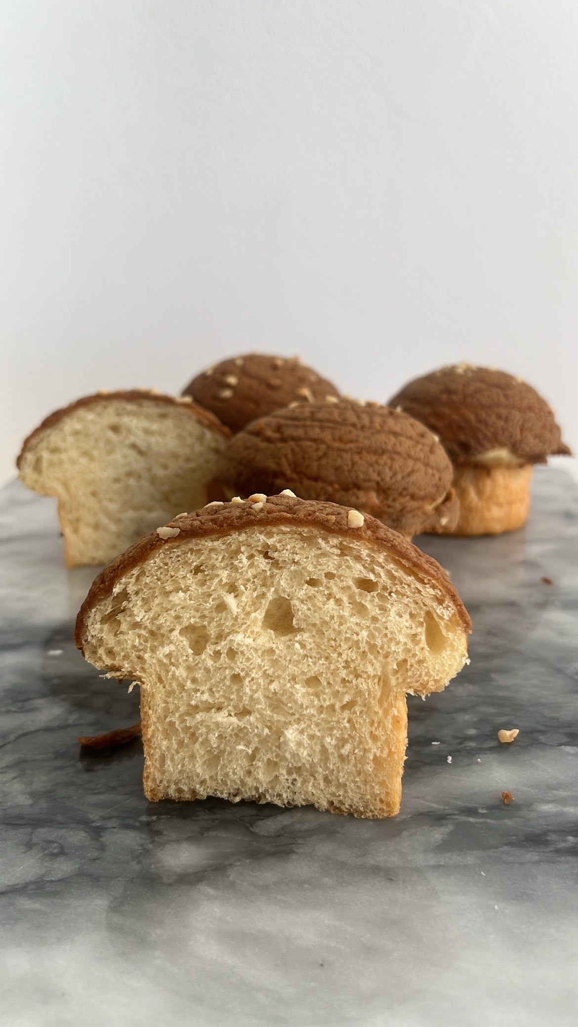 Mushroom bread sliced into half, showing the fluff texture inside