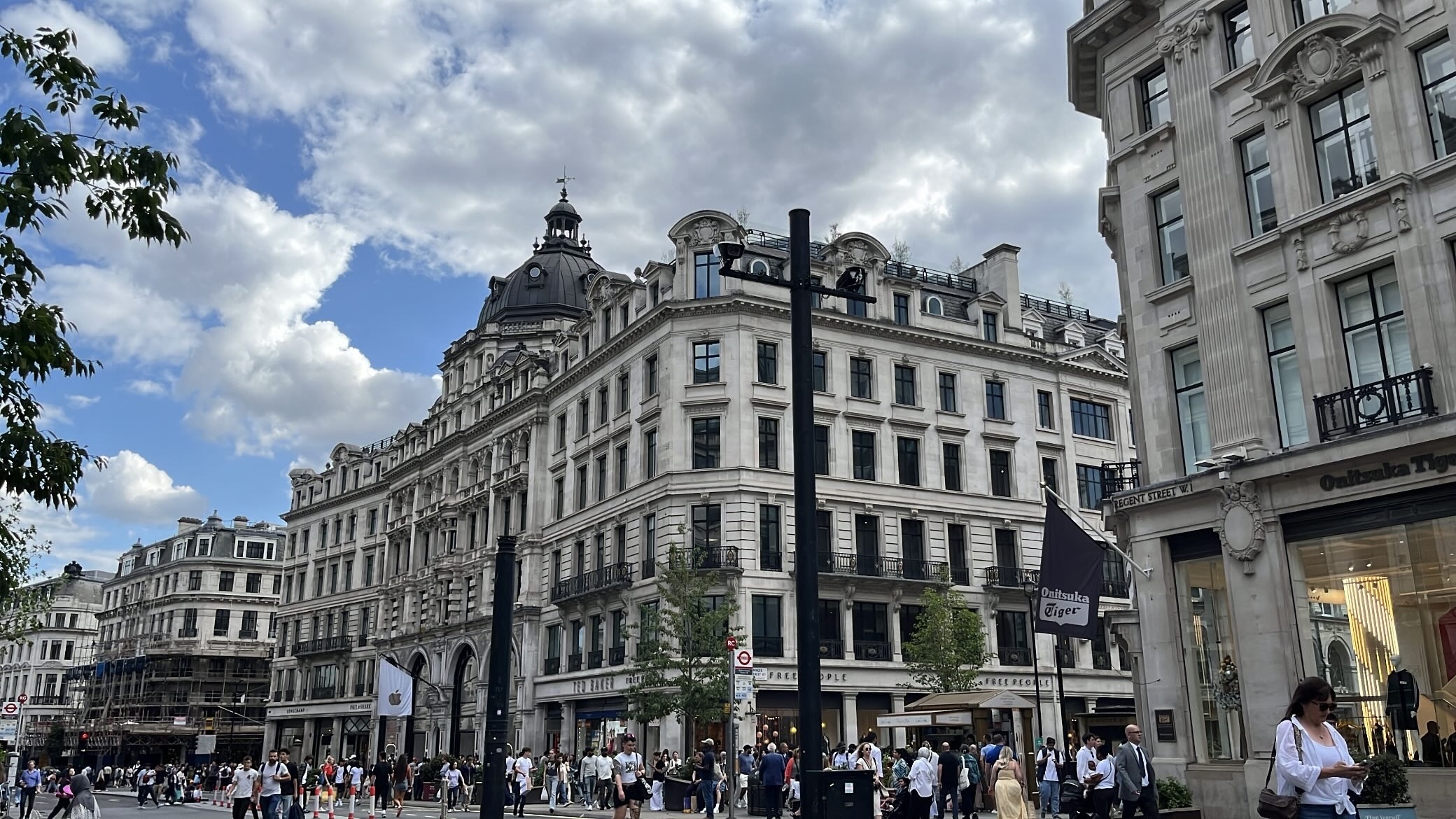 A picture of Regent Street in London, showing the iconic curved architecture and bustling street scene.